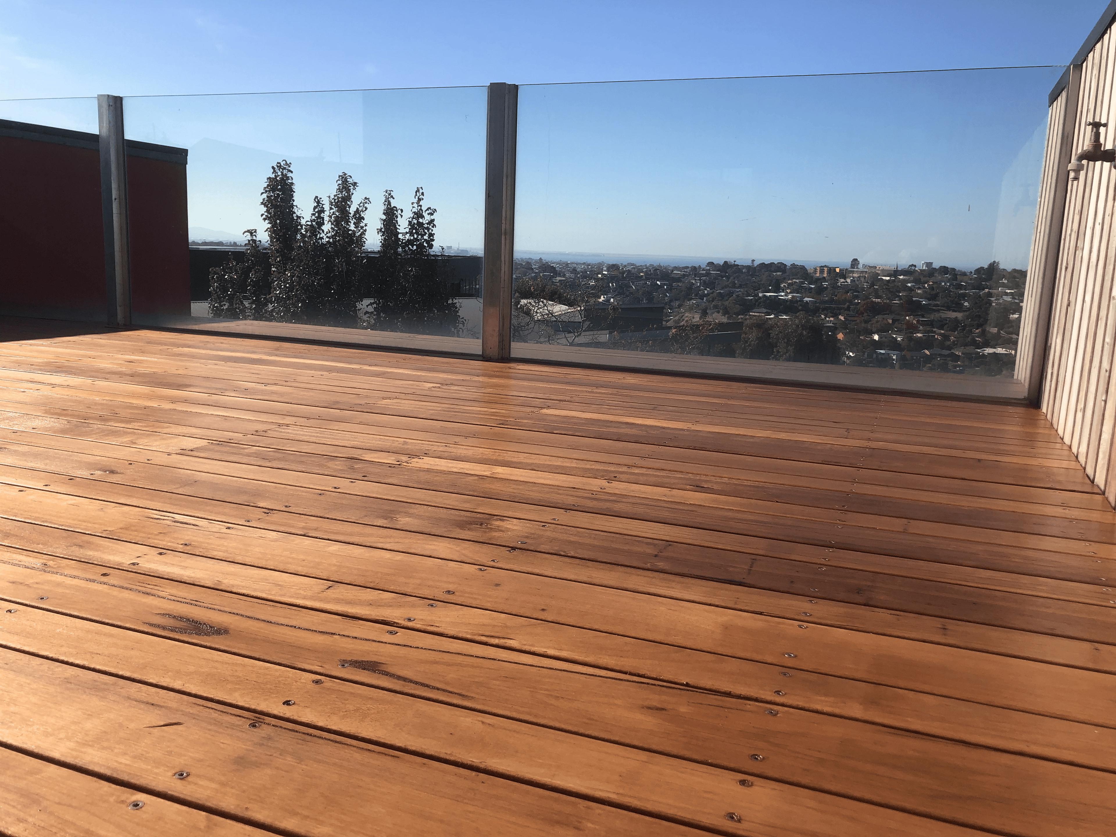 Freshly stained timber deck with a clear outlook over the bay